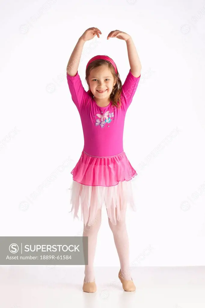 A Girl Posing As A Ballerina With Ballet Shoes