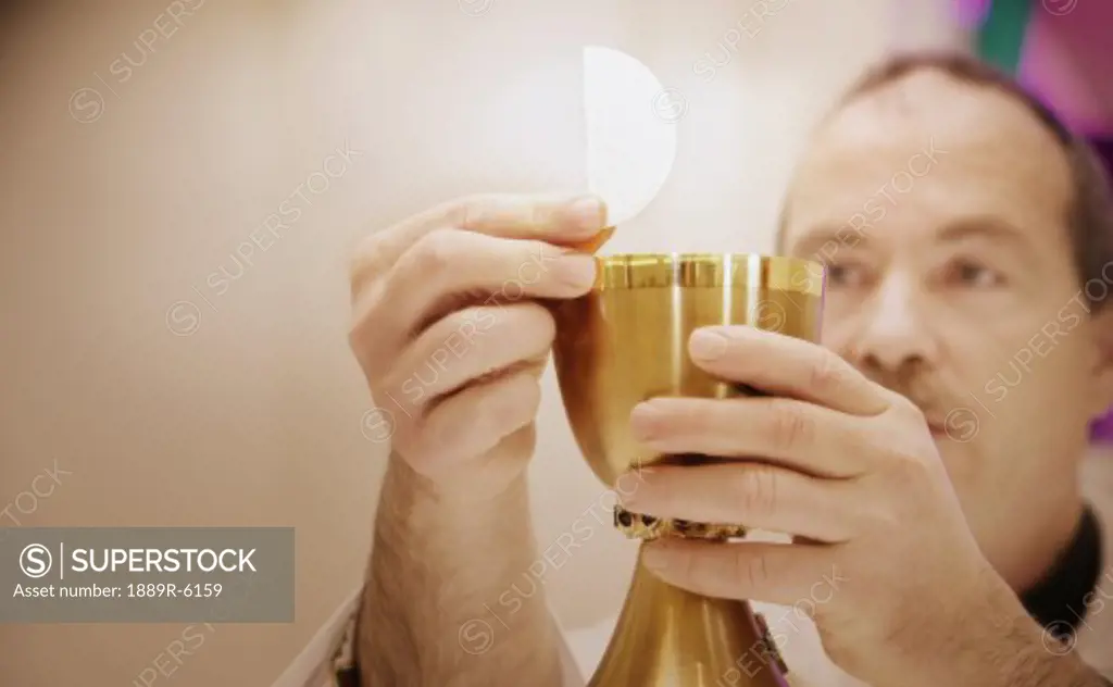 Priest holding sacraments