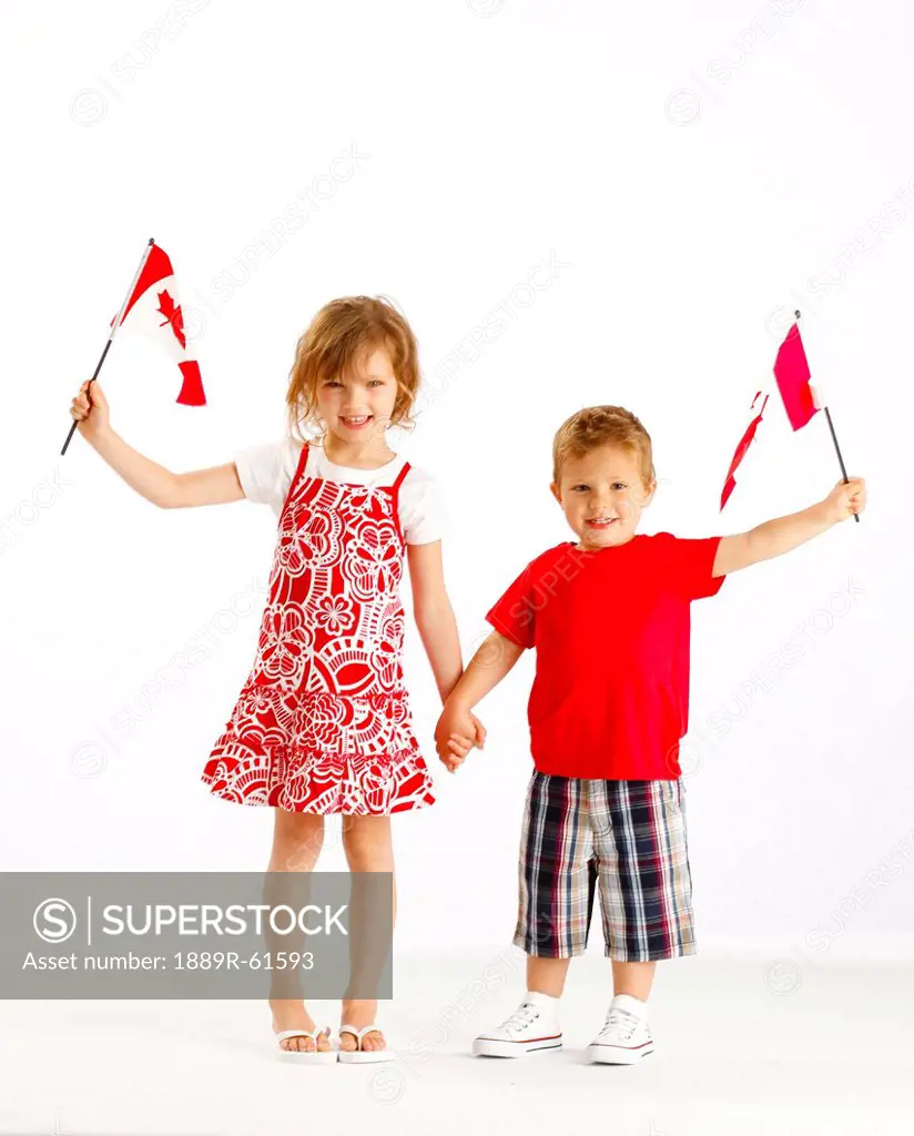 Two Children Holding Canadian Flags