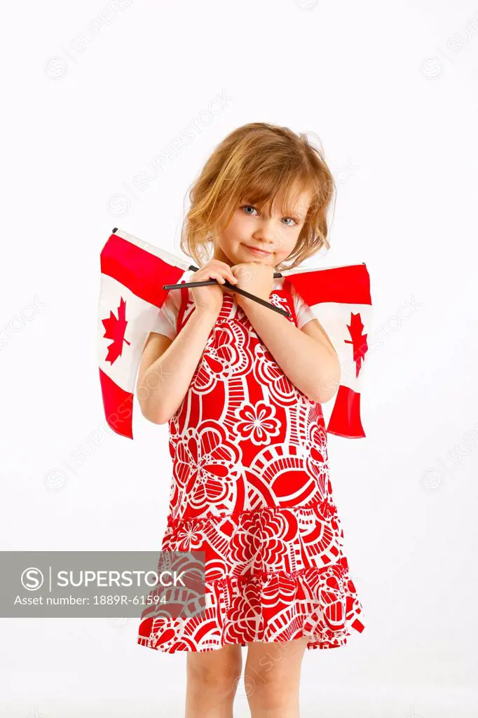 A Girl Holding Two Canada Flags