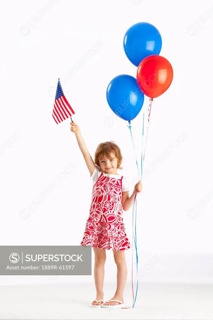 A Girl Holding Red And Blue Balloons And An American Flag