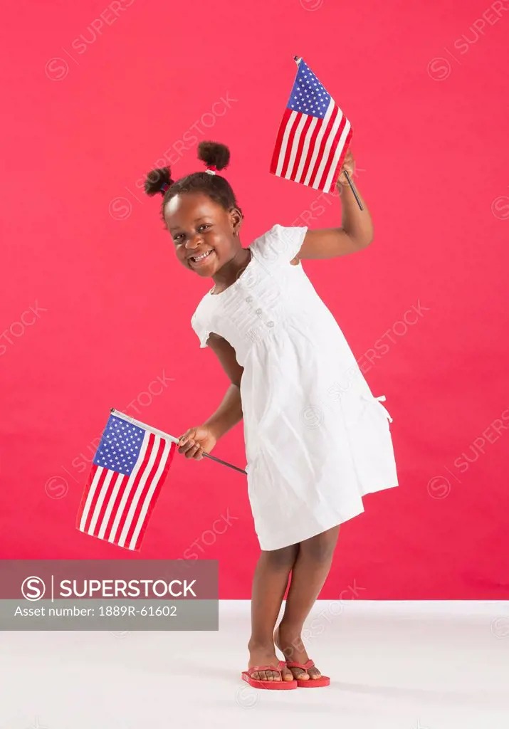 A Girl Holds Two American Flags