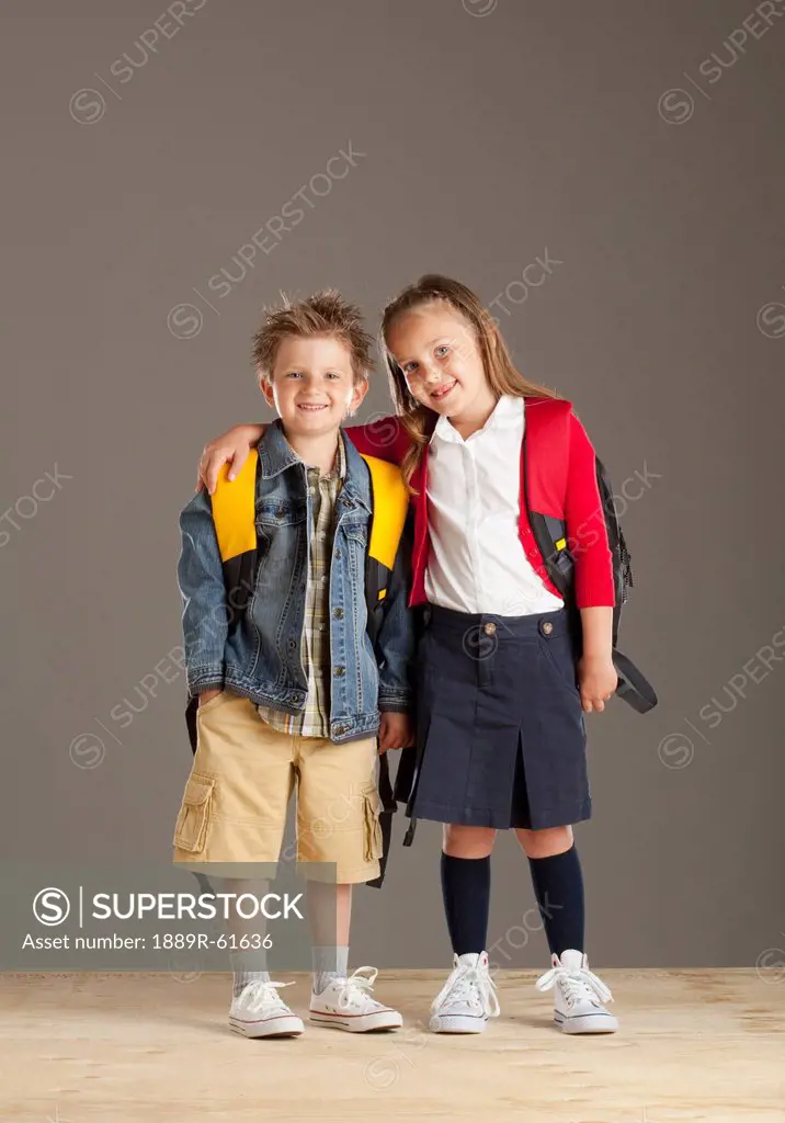 A Boy And Girl Carrying Backpacks