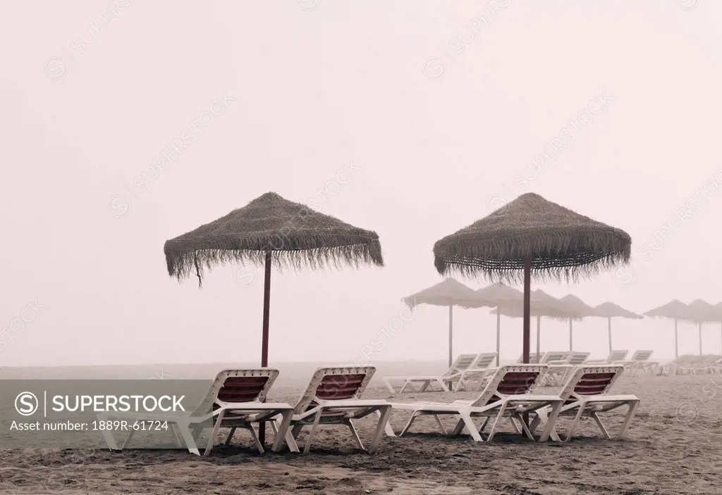 Sunbeds And Umbrella On Playamar Beach In Off_Season On A Foggy Day, Torremolinos, Malaga, Costa Del Sol, Spain