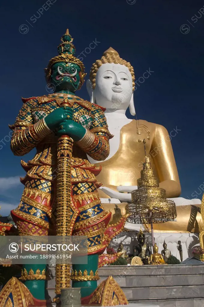 wat doi kham temple statue with guardian giant, chiang mai, thailand
