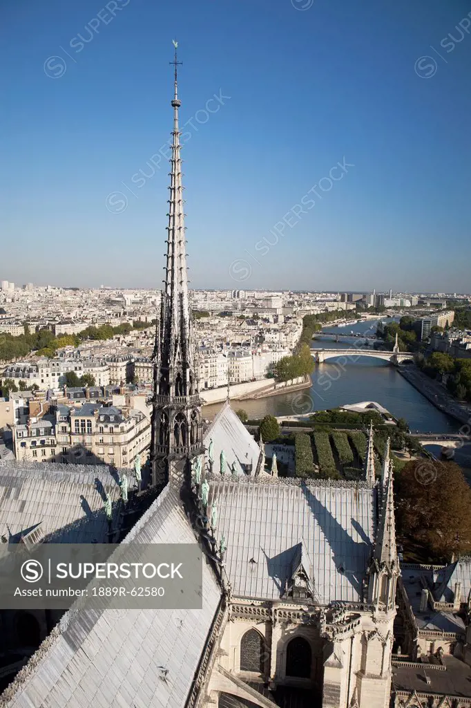roof tops of the back side of notre_dame cathedral with a spire, paris, france