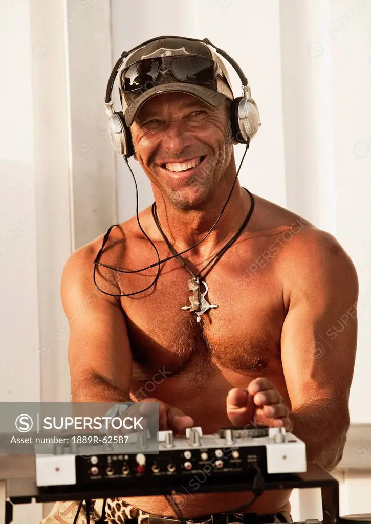 a disc jockey playing music at explora beach bar, tarifa, cadiz, andalusia, spain