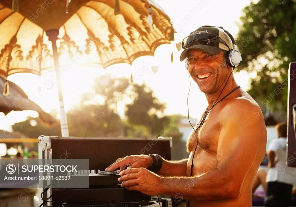 a disc jockey playing music at explora beach bar, tarifa, cadiz, andalusia, spain