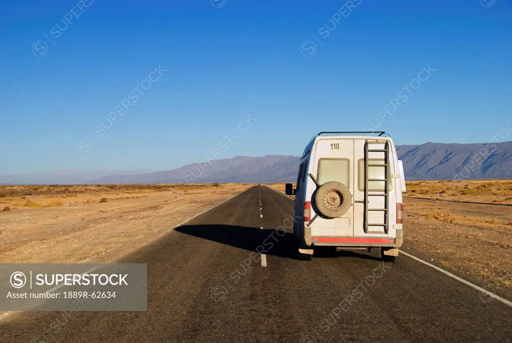 camper van on a road outside cafayate, salta, argentina