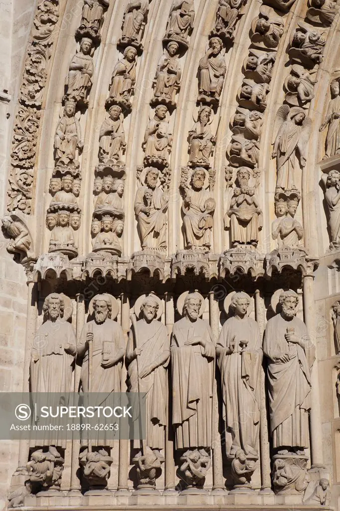 detail of some of the apostle statues of the last judgement on the last judgement and central portal at notre_dame cathedral, paris, france