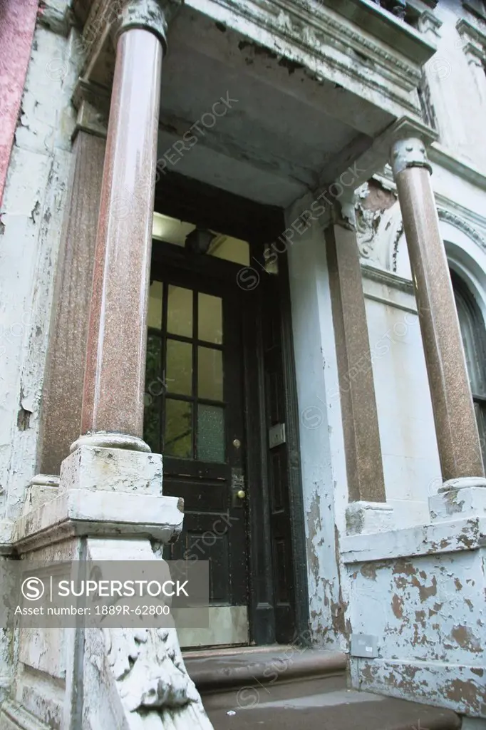 a front entrance in front of a building with peeling paint and columns, troutdale, oregon, united states of america