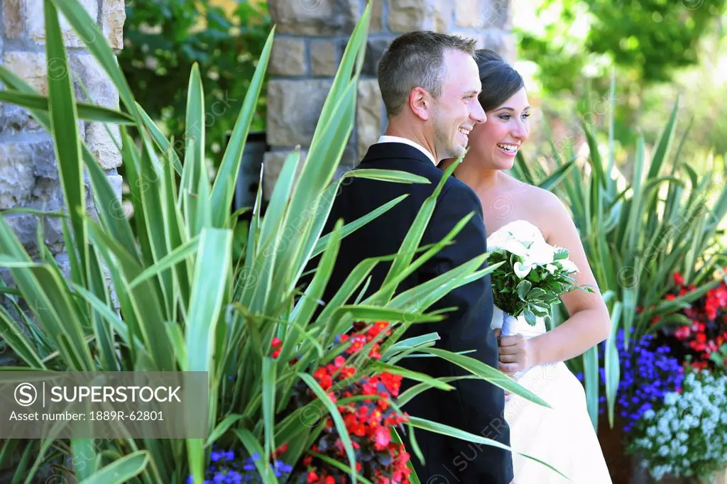 a bride and groom posing for pictures in a garden area, troutdale, oregon, united states of america