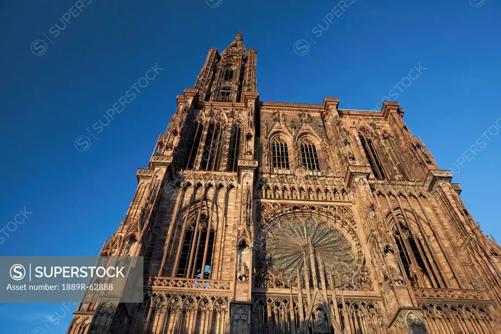 low angle of a cathedral against a blue sky, strasbourg, france