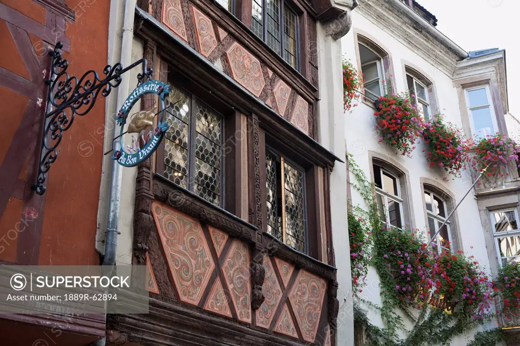 detail of medieval timber style buildings decoratively painted with flower boxes, strasbourg, france