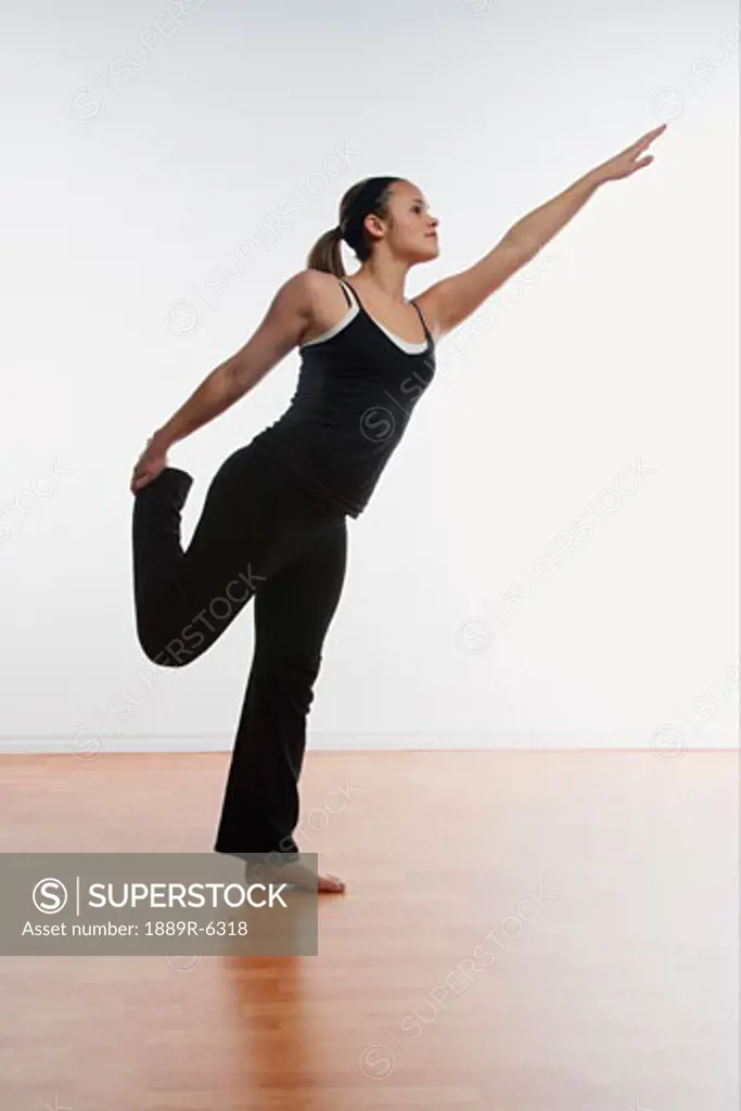 Woman does a balancing stretch
