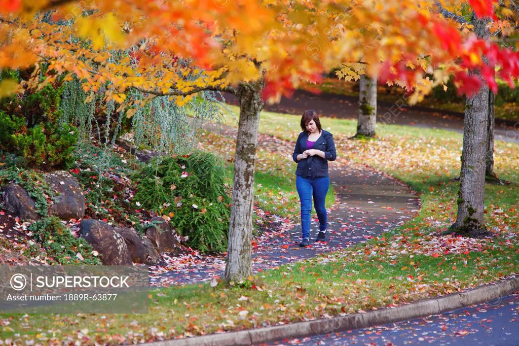 a girl walking along a trail in autumn, portland, oregon, united states of america