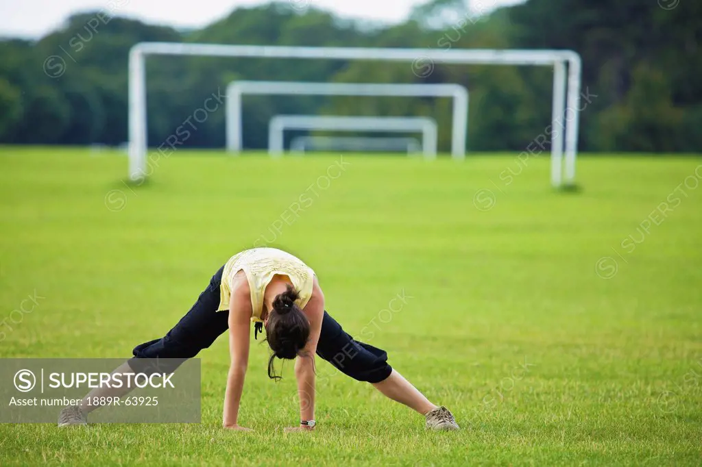 a woman exercising in the phoenix park, dublin, ireland
