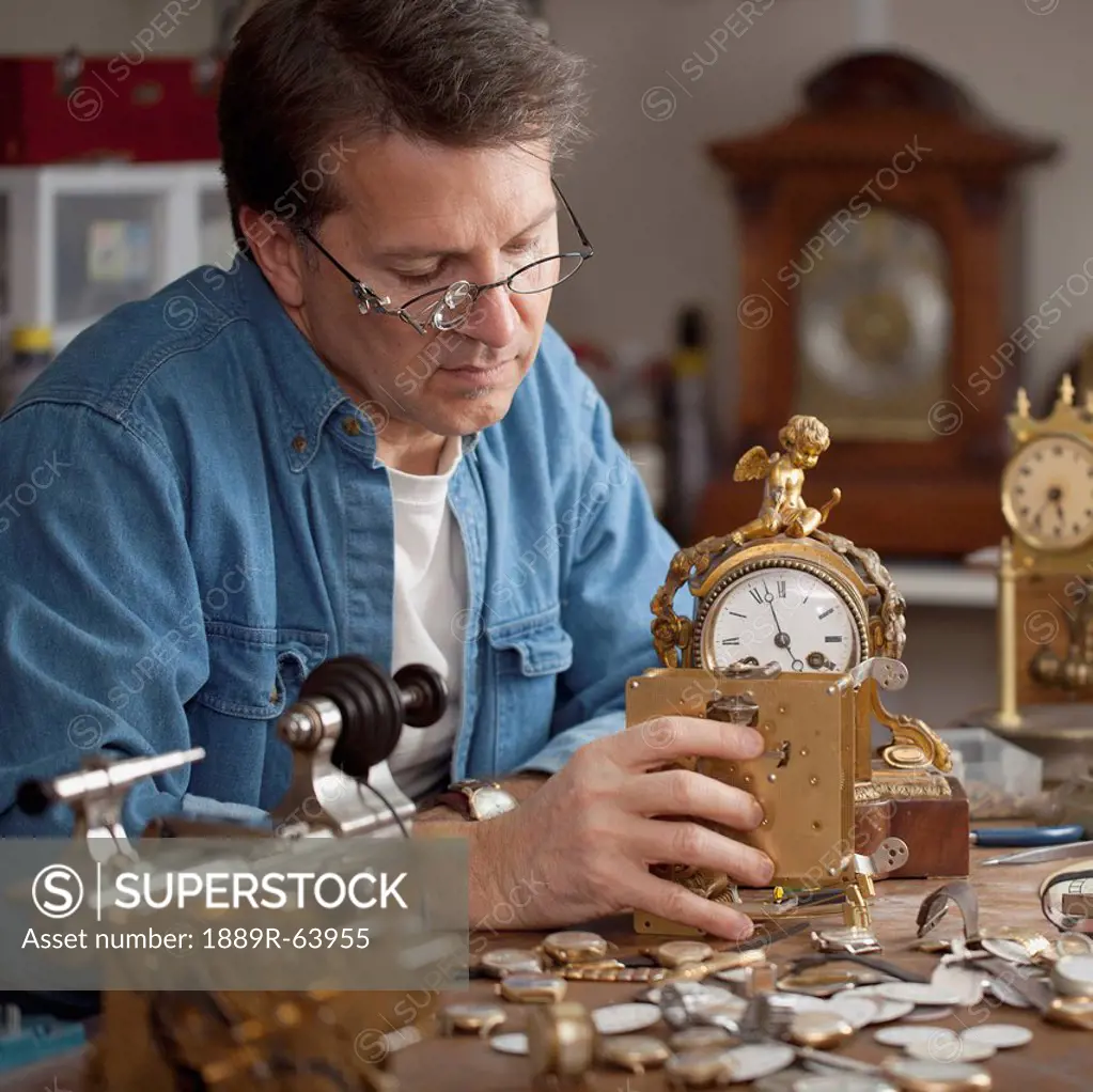 a man repairing clocks, st. catharines, ontario, canada