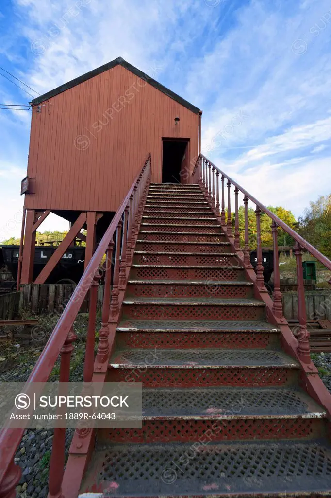 stairs leading up to an elevated building along the train tracks, beamish, durham, england