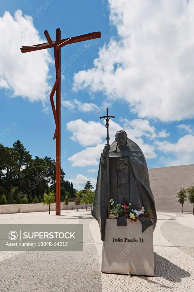 the high cross and a statue of pope john paul ii at the basilica of fatima, fatima, estremadura and ribatejo, portugal