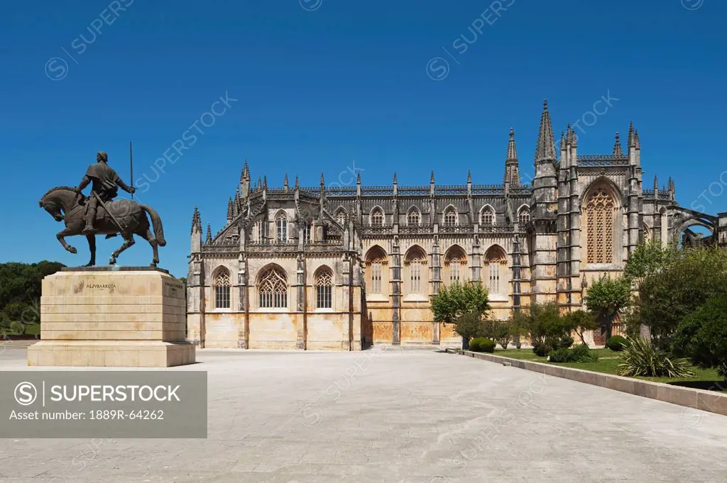 14th century monastery of santa maria of victoria, better known as batalha battle abbey with monument to nvno alvares pereira 1360 _ 1431 in the foreg...