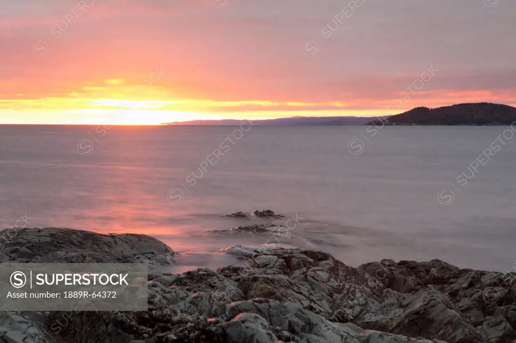 rocky shoreline of lake superior at sunset, wawa, ontario, canada