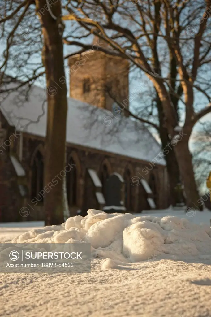 pile of snow outside of church in winter, whitburn, tyne and wear, england