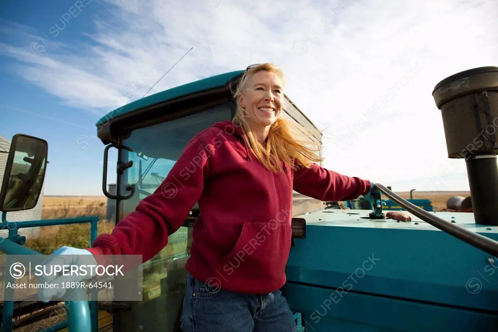 woman gassing up farm machinery, three hills, alberta, canada