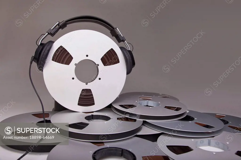 headphones on a reel of recording tape