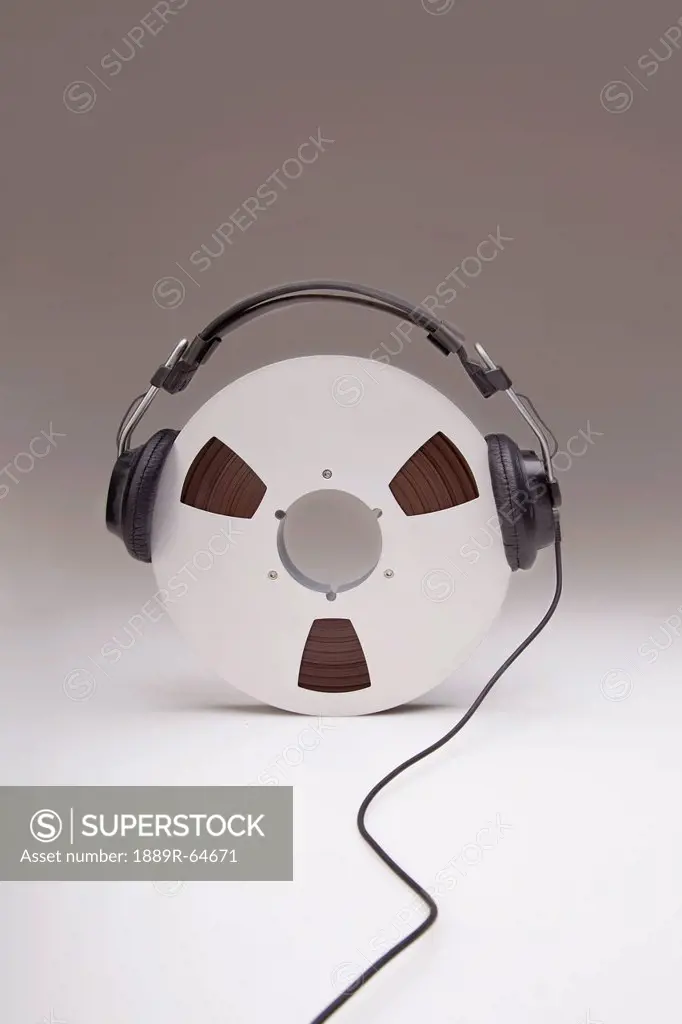 headphones on a reel of recording tape