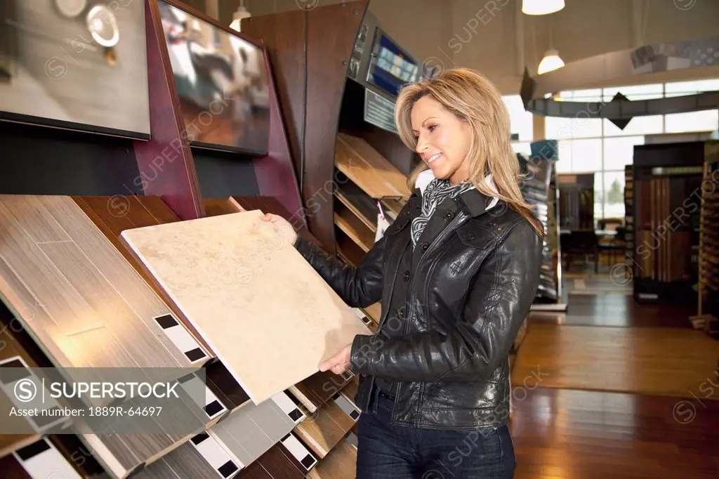 customer choosing floor coverings in a retail floor establishment, edmonton, alberta, canada