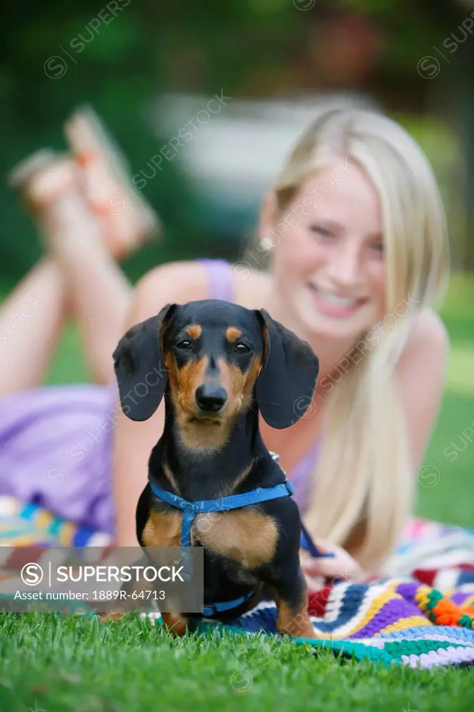 woman relaxing with her miniature dachshund, victoria, vancouver island, british columbia, canada