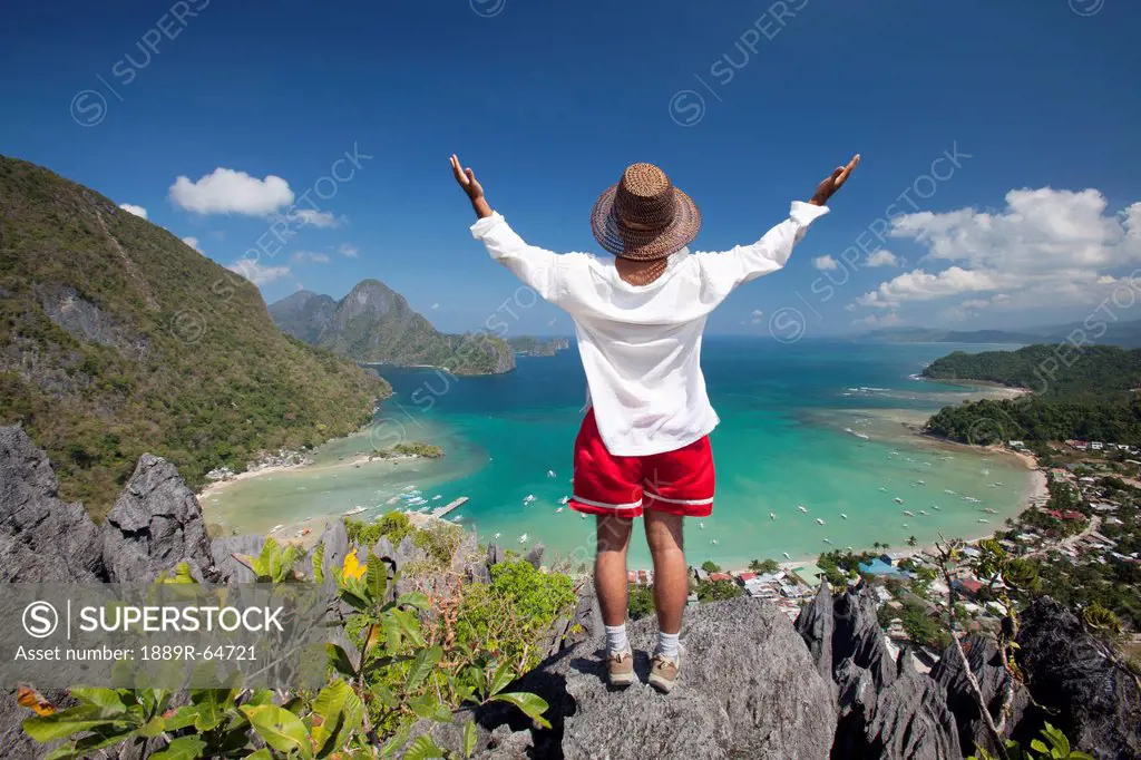 man standing above tropical water, el nido, palawan, philippines