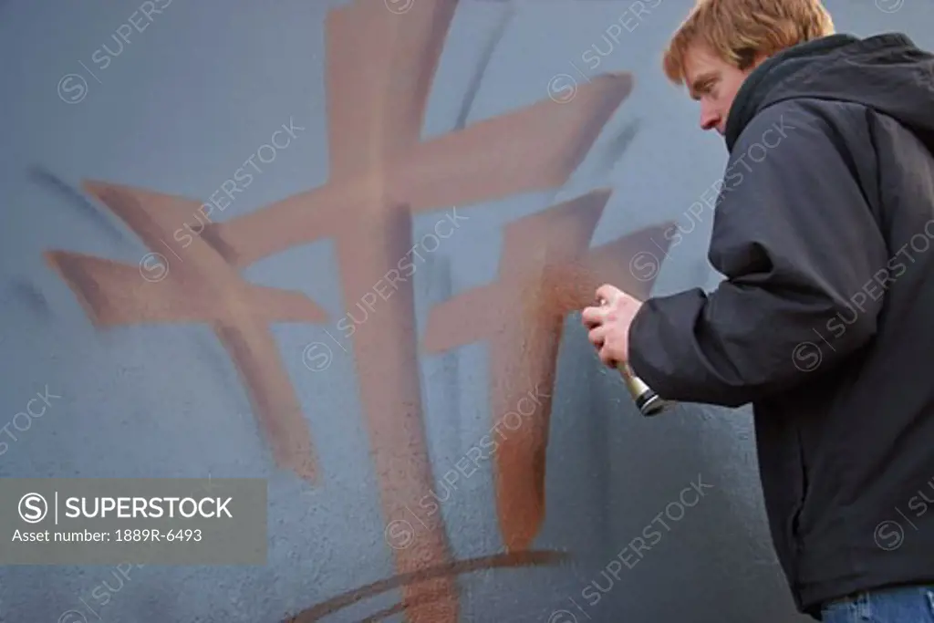 Man spray painting crosses