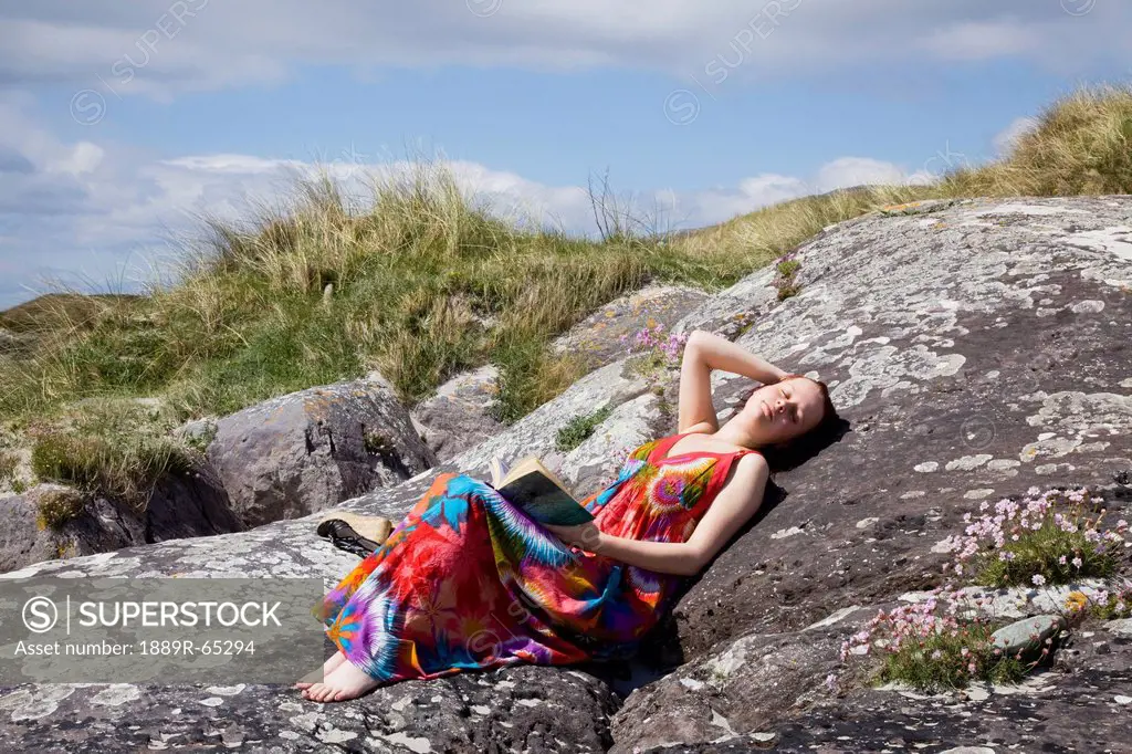 woman relaxing at beach, derrynane beach, county kerry, ireland
