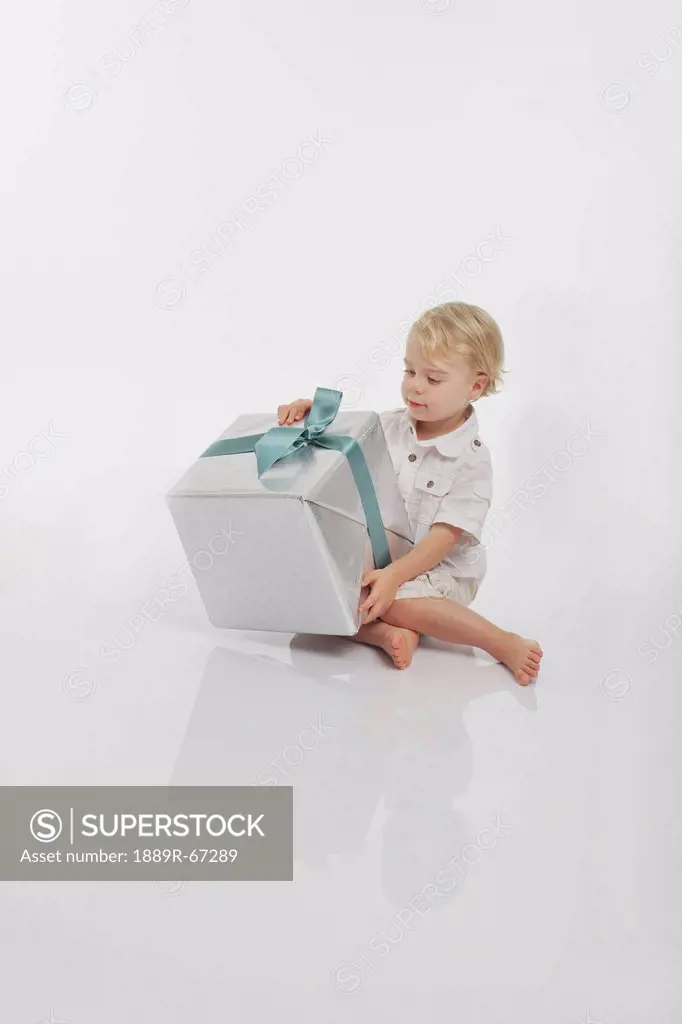 toddler looking at a wrapped gift