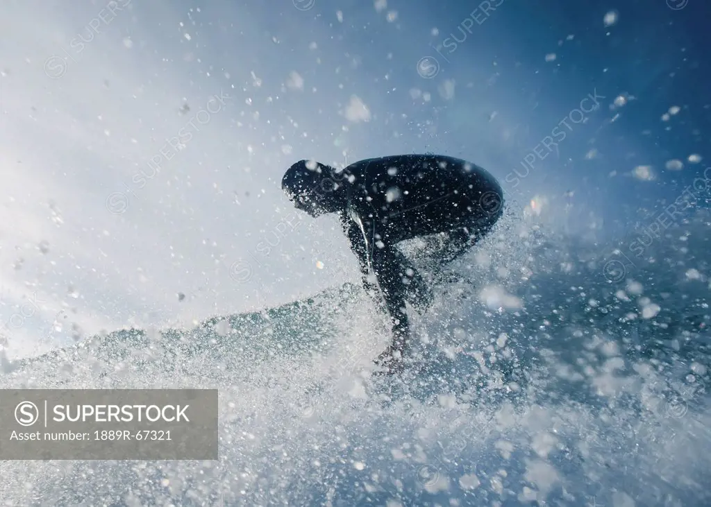 a man surfing off bunker beach, tarifa, cadiz, andalusia, spain