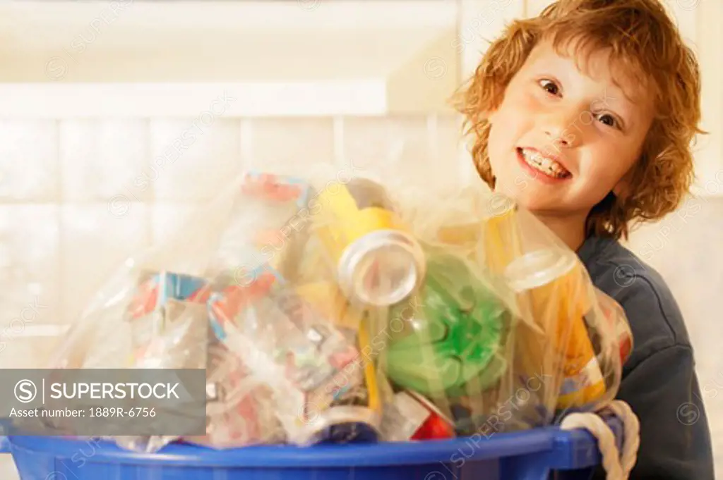 Boy holding bottles to be recycled