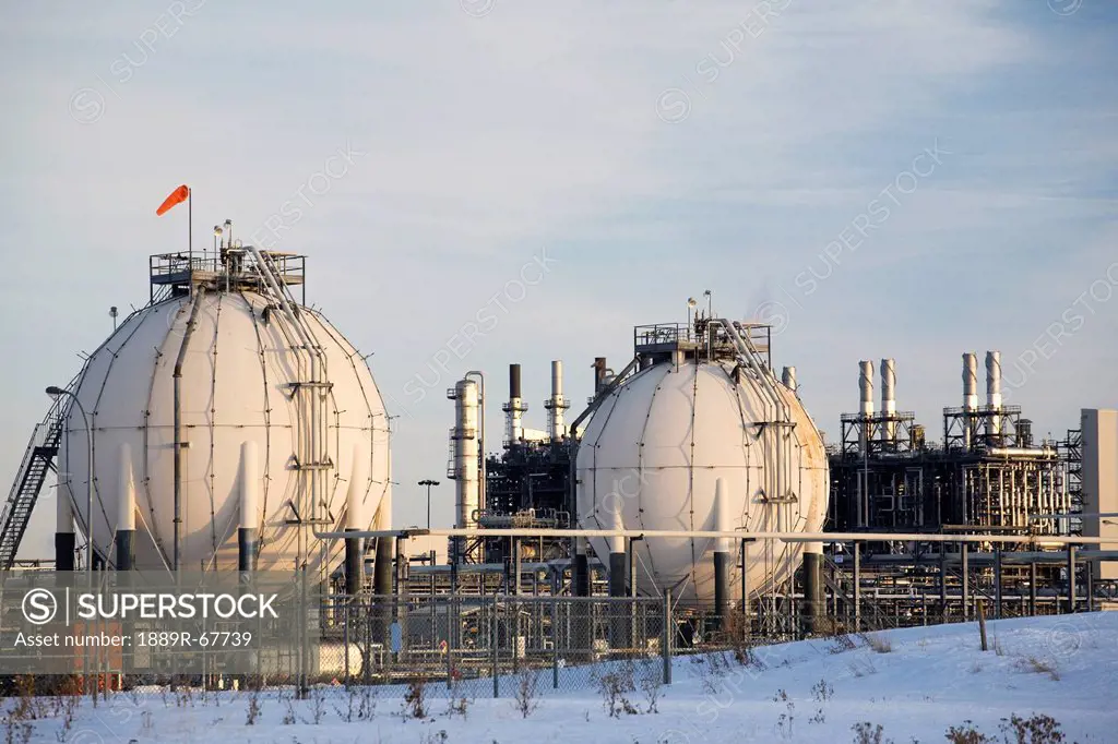 spherical oil tanks and refinery in winter at sunset, fort saskatchewan, alberta, canada