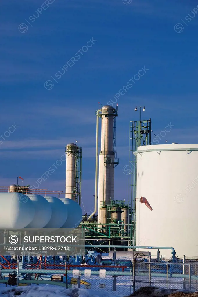 oil tanks and refinery towers in winter at sunset, fort saskatchewan, alberta, canada