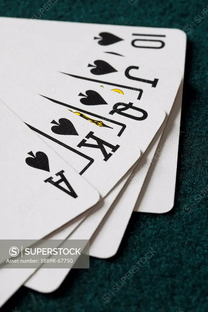 close_up of blackjack playing cards showing spades royal flush
