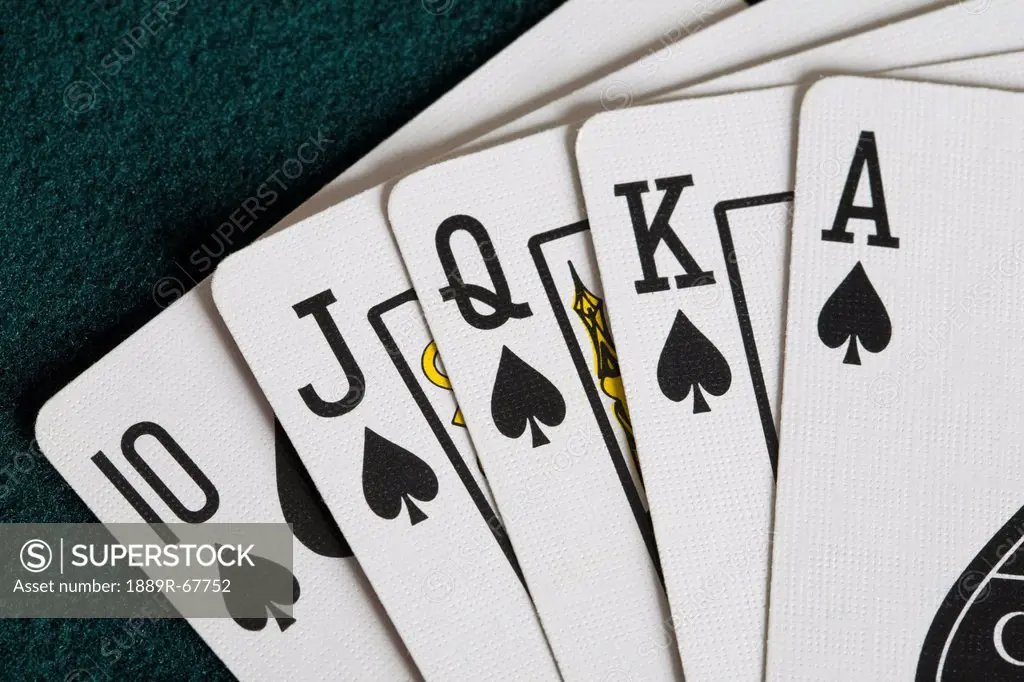 close_up of blackjack playing cards showing spades royal flush
