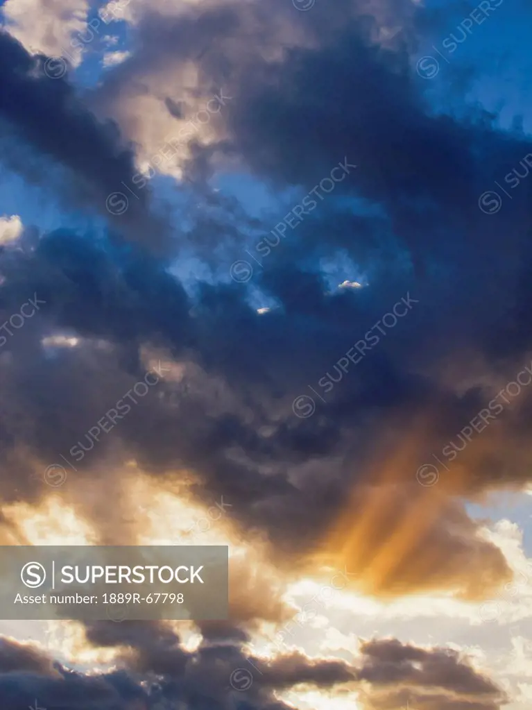 sun rays bursting out from behind clouds