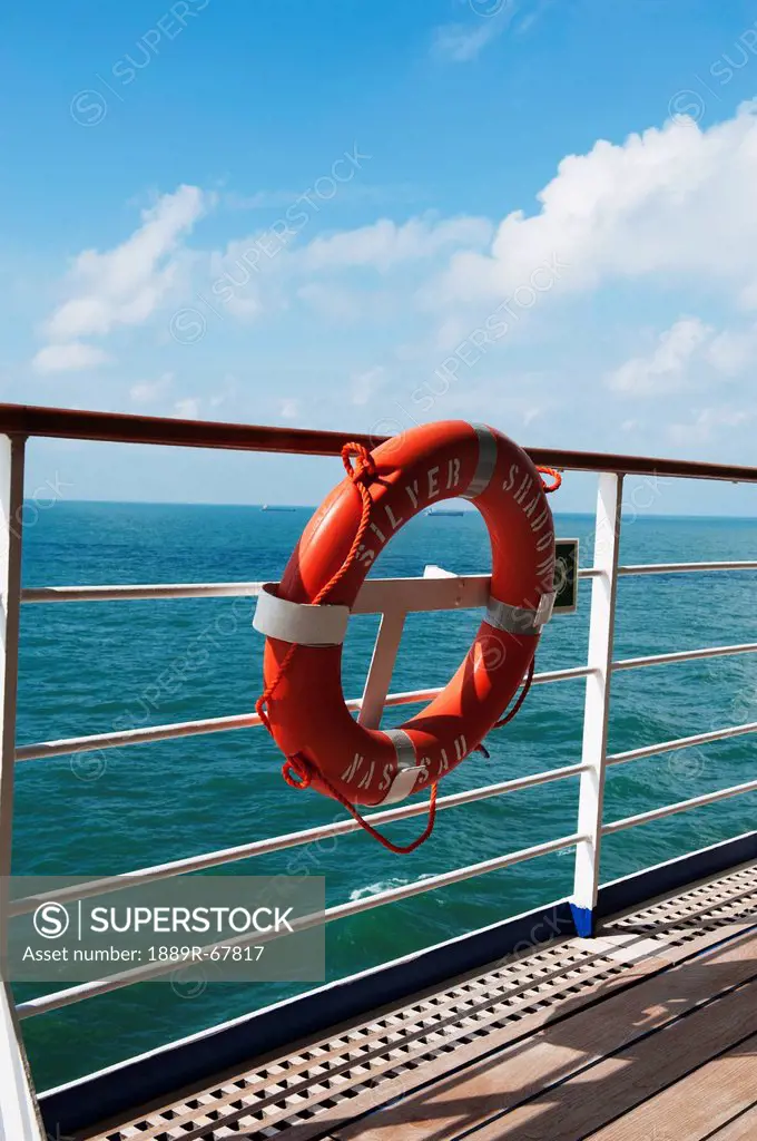a lifebuoy hanging on the railing of the silver shadow cruise ship in the east china sea, china
