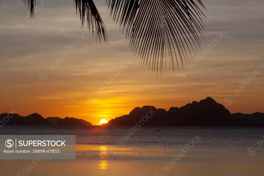 sunset view of tropical islands from the beaches of corong corong, el nido, bacuit archipelago, palawan, philippines