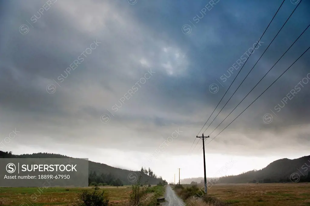 a road through a rural area with power lines overhead near hobuck beach, washington united states of america