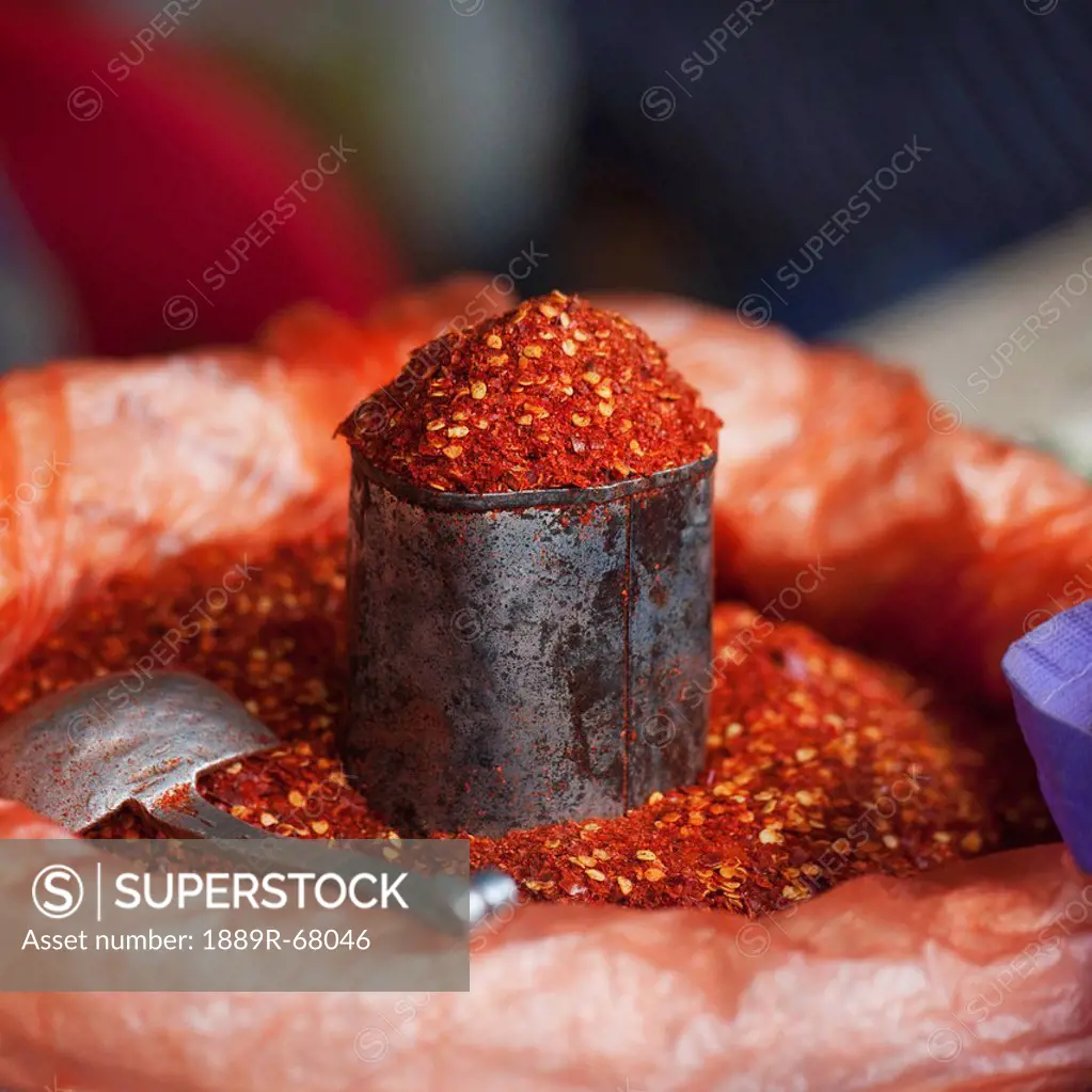 chili powder in a container with a scoop at a market, thimphu thimphu district bhutan