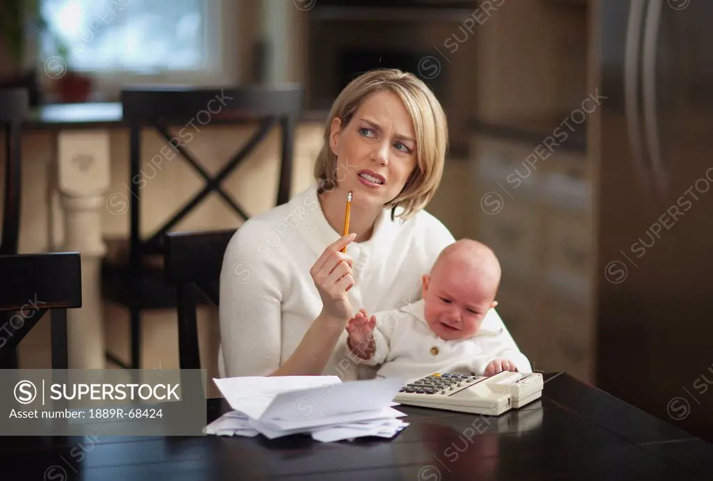 mother with baby stressing over household finances, jordan ontario canada