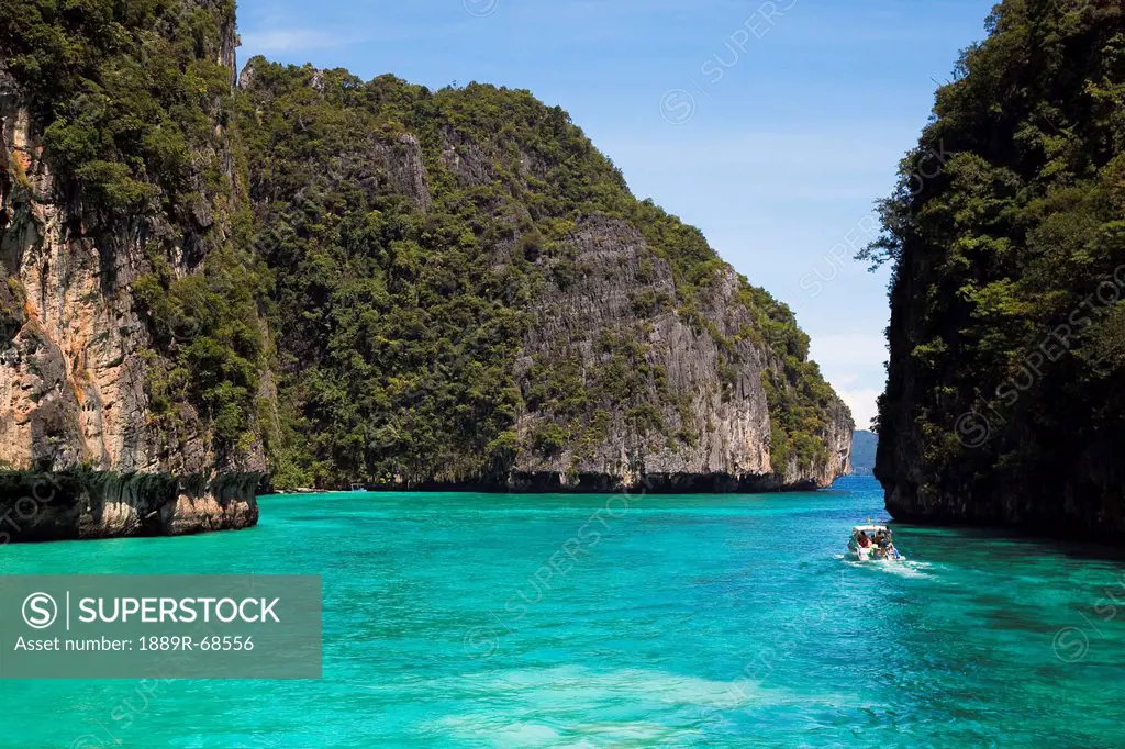 a snorkeling boat in the island waterway near koh phi phi, phuket thailand