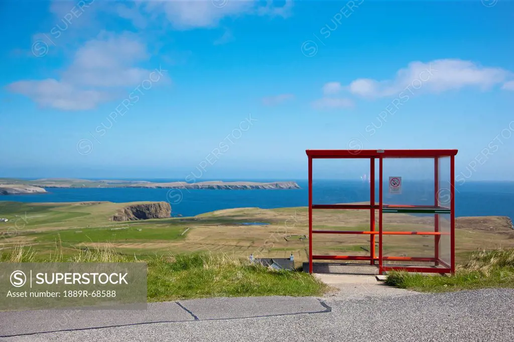 a red shelter on the side of the road, shetland scotland